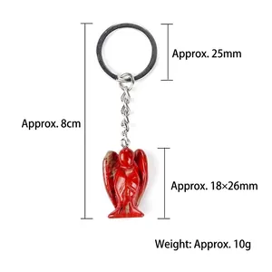 Red jasper carved angel keychain with silver metal ring on white background, 8cm total length