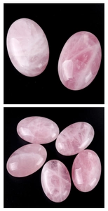 Detailed view of polished oval rose quartz palm stone with natural icy textures