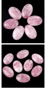 Close-up of polished rose quartz palm stones with natural textures and icy veins