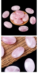 Macro shot of smooth polished rose quartz palm stones on a rustic wooden tray and rattan
