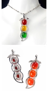 Detail of silver bean pendant featuring red, yellow and green chalcedony stones