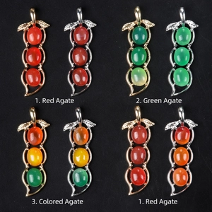 Jadeite bean pod pendant with red and green agate gemstones in gold and silver settings