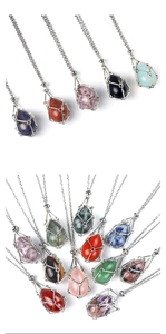 Macro shot of assorted crystal gemstones in silver wire cage pendants on fine chains