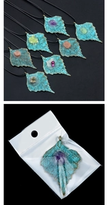 Detail of maple leaf alloy pendant with mixed raw gemstones in OPP packaging bag