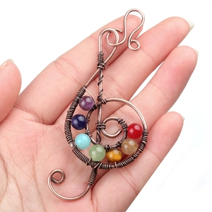 Handcrafted bronze musical treble clef pendant featuring seven colorful chakra gemstones