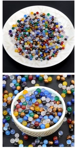 Close-up of polished 4mm natural stone beads in a ceramic bowl for jewelry DIY