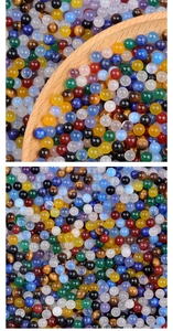 Macro shot of assorted 4mm polished natural stone beads in a wooden spoon for DIY jewelry