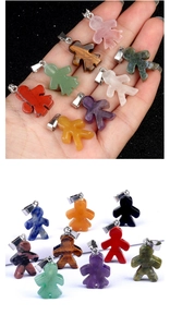 Macro detail of natural agate boy and girl pendants with various colorful gemstones