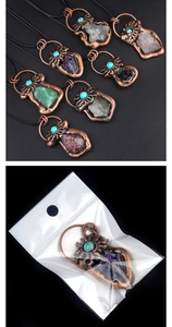 Detail view of vintage bronze crystal pendants with various raw gemstones and turquoise