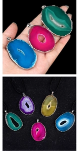 Detailed macro of various colorful agate slice pendants with elegant silver gilded edges
