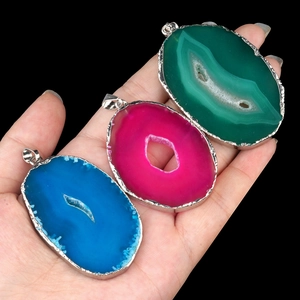 Natural agate slice pendants with gold-plated edges in blue, magenta, and green hues