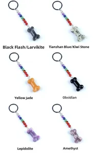 Close-up of bone-shaped natural crystal pendants with colorful chakra bead keychains