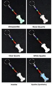 Variety of colorful crystal bone pendants with chakra beads on keyrings in macro detail