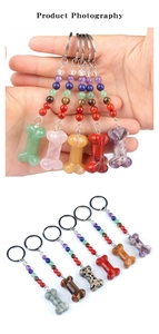 Detailed view of bone-shaped crystal keychains with colorful chakra beads and silver rings