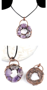 Close-up of vintage bronze donut pendant with raw purple amethyst stones and cord