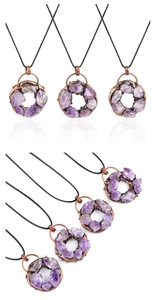 Detailed view of handmade purple amethyst cluster donut pendants on black cord necklaces