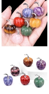 Mini natural amethyst and agate pumpkin carvings in hand for size comparison and scale