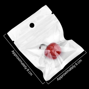 Miniature cherry ornament in clear packaging bag with dimensions labeled on black backdrop