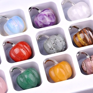 Assorted mini semi-precious gemstone pumpkins with silver stems in a display tray