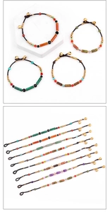 Detail of handmade bohemian beaded bracelets featuring natural semi-precious stones and bells