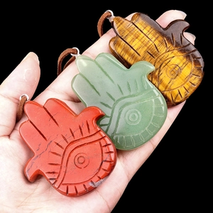 Natural Hamsa Hand stone pendants in tiger eye and jasper on black background