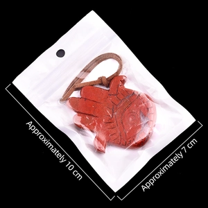 Red jasper Hamsa Hand pendant with brown leather cord in a 10x7cm plastic package