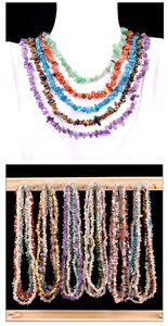 Detailed view of layered irregular amethyst and agate stone necklaces on display