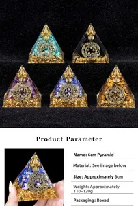 Detail view of 6cm handmade resin energy pyramid with natural stones and gold leaf
