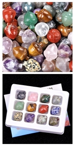 Macro shot of 12 assorted crystal gemstone acorns with a 16-slot white display tray