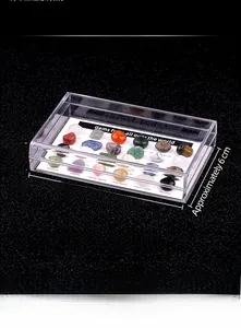 Macro detail of mixed mineral specimens and agate gemstones in an acrylic display box