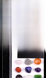 Collection of 24 polished mini gemstones in a labeled clear acrylic specimen display case