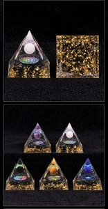 Detail view of various Orgone Pyramids featuring diverse natural stone spheres and metal Om symbols