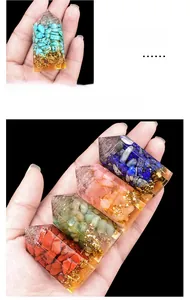 Macro detail of a resin crystal tower with colorful gemstones and gold leaf flakes