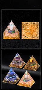 Detail view of handmade Orgone pyramid with natural stones and Tree of Life symbol