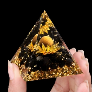 5cm Orgone Pyramid with Tiger Eye sphere, lotus flower, and obsidian base held in hand