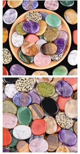 Macro detail of polished natural oval worry stones including amethyst and tiger eye crystals