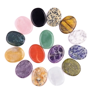 Polished oval worry stone set featuring 14 natural healing crystals on white background