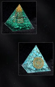 Detail view of resin Orgone pyramids with malachite and turquoise stones on a dark background