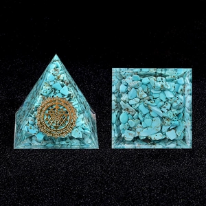 Orgone energy pyramid with blue turquoise stones and golden Sri Yantra geometry