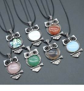 Detailed collection of seven vintage owl necklaces with various natural semi-precious stones