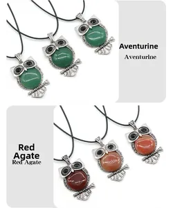 Detail of owl pendants with aventurine and red agate stones on antique silver base
