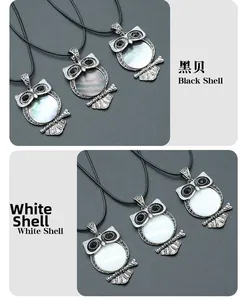 Detailed view of owl pendants with black and white shell inlays on retro silver metal