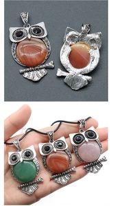 Close-up of gemstone owl pendants in vintage zinc alloy with various semi-precious stones