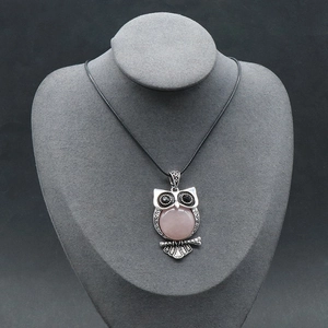 Vintage silver owl necklace featuring a round pink crystal stone on a black cord