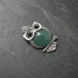 Vintage silver owl pendant necklace featuring a green semi-precious stone and ethnic details