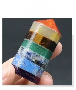 Macro detail of hand-held natural seven chakra multi-layer hexagonal crystal pillar