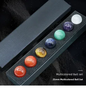 Detailed view of 7 colorful 25mm chakra crystal spheres in a black protective gift box