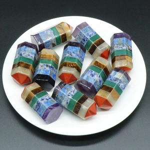 Polished natural seven chakra healing crystal hexagonal towers on a ceramic plate