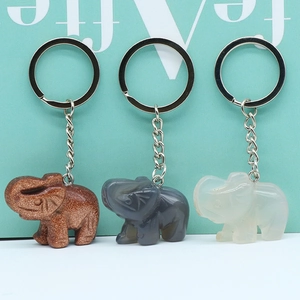 Three elephant-shaped stone keychains in gold, grey, and white with silver metal rings