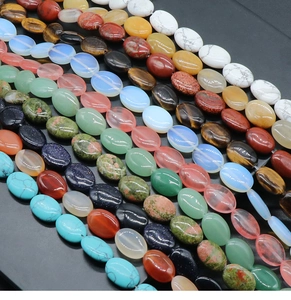 Close-up of assorted 13x18mm oval gemstone beads including tiger eye and turquoise